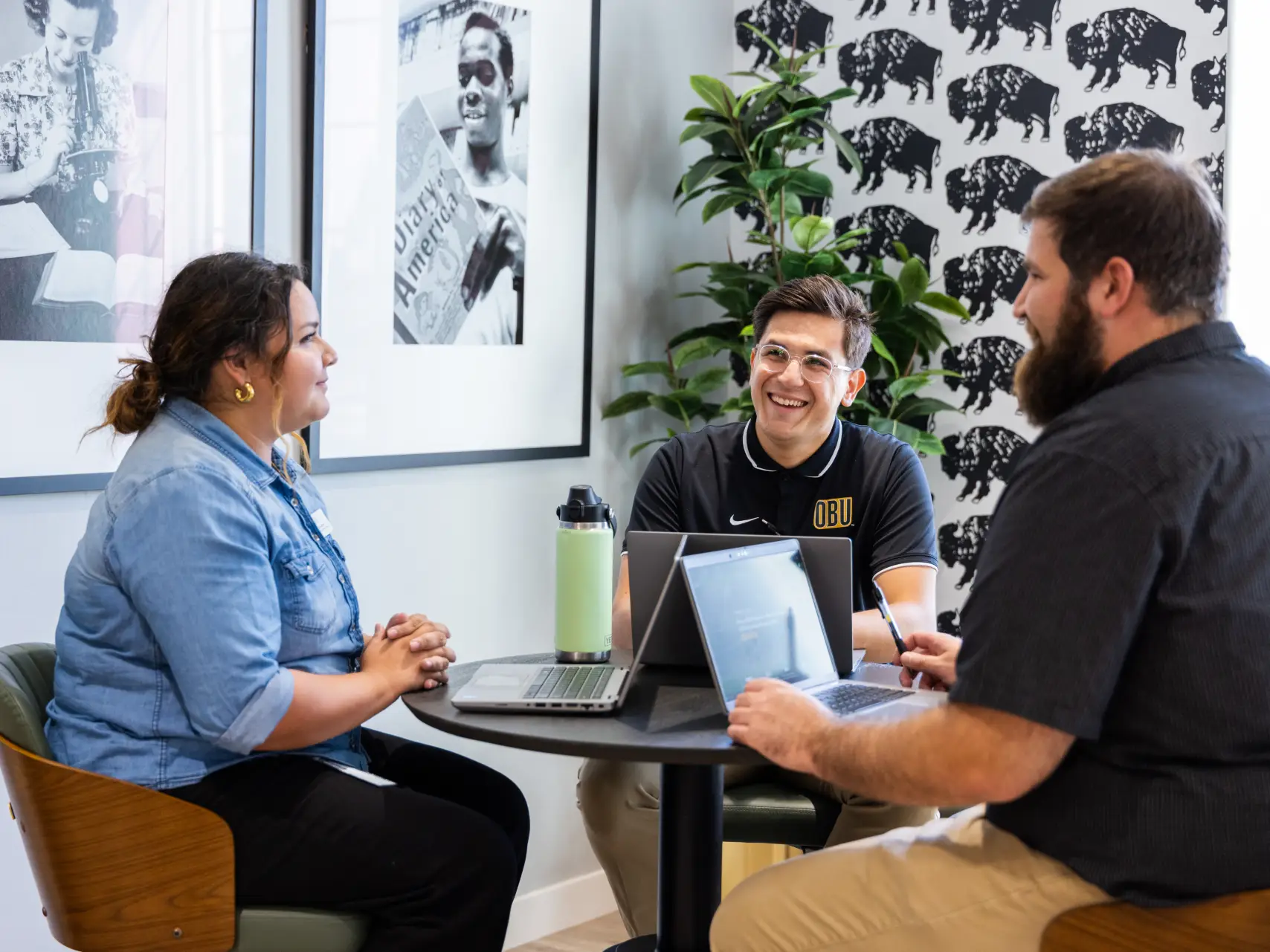 Admission Counselors sitting around a desk talking.
