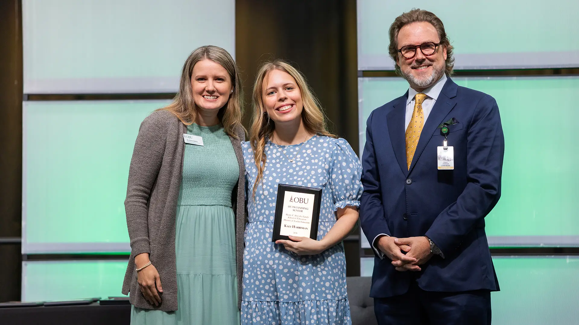 Dr. Annie Keehn, chair of the School of Education, left, and OBU President Dr. Heath A. Thomas, right, presented the Outstanding Senior Award from the Henry F. McCabe School of Education to Kali Harriman, center.