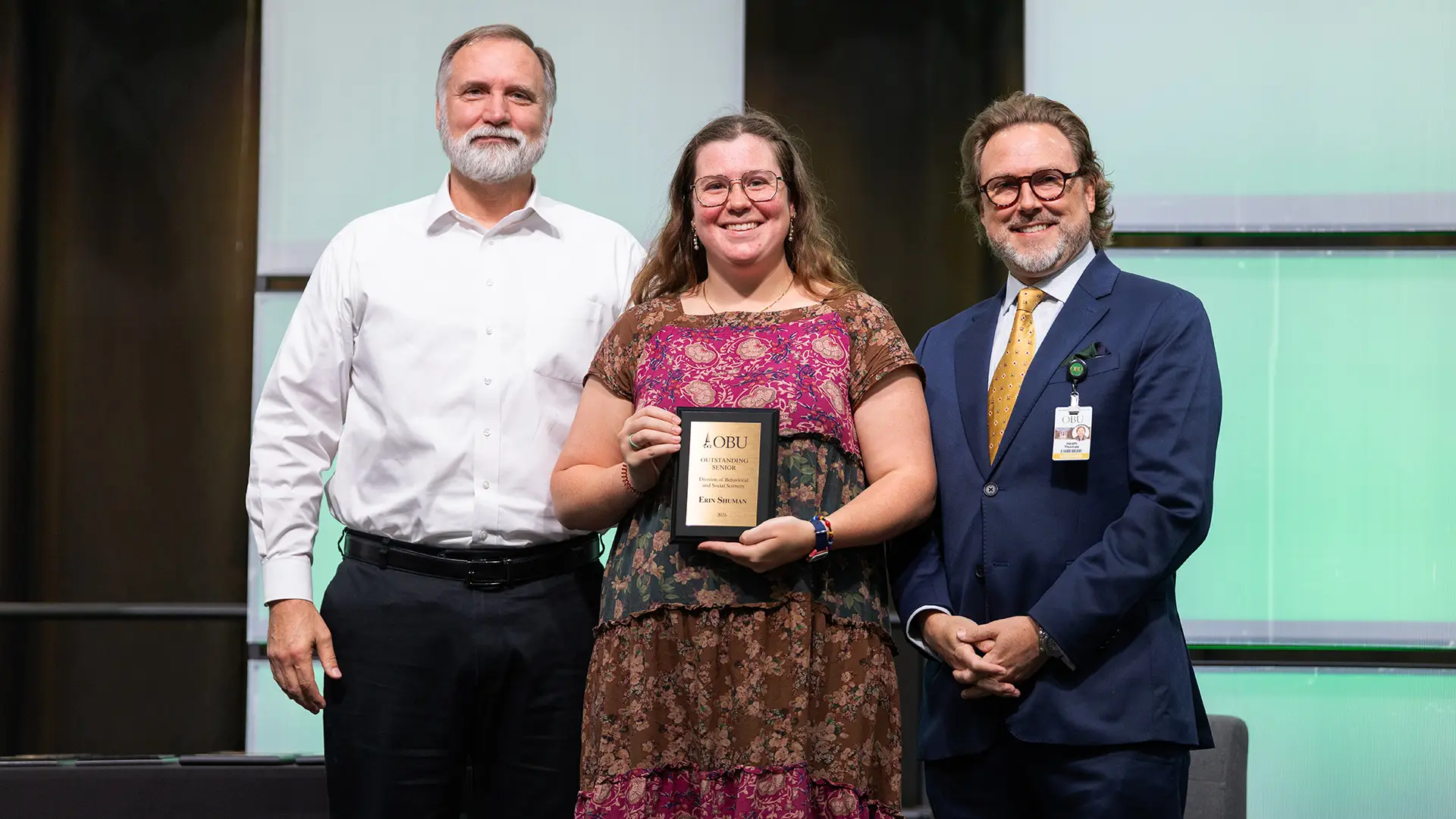 Dr. Bret Roark, chair of the Division of Behavioral and Social Sciences, left, and OBU President Dr. Heath A. Thomas, right, presented the Outstanding Senior Award from the Division of Behavioral and Social Sciences to Erin Dyer Shuman, center.