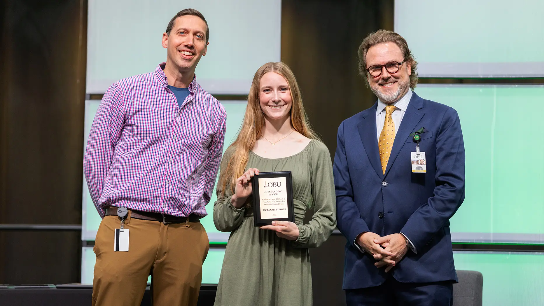 Benjamin Baxter, chair of the Division of Art and Design, left, and OBU President Dr. Heath A. Thomas, right, presented the Outstanding Senior Award from the Division of Art and Design to McKenzie Stewart, center.