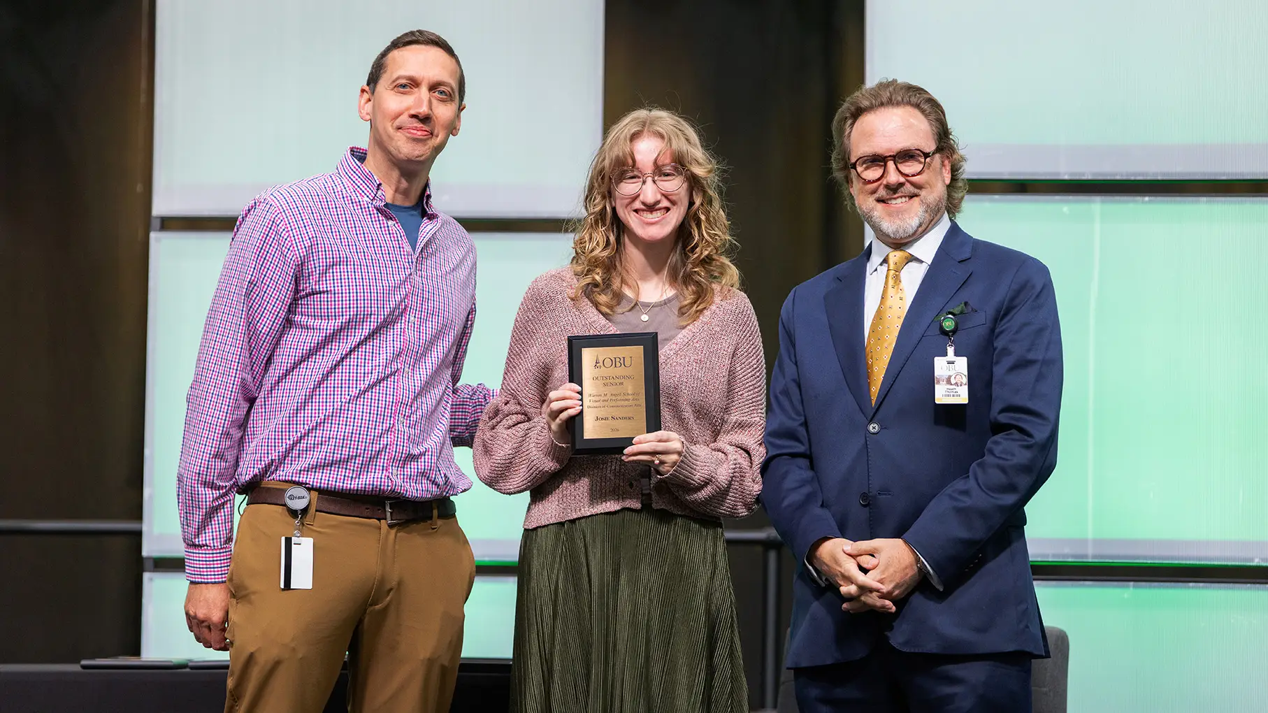 Benjamin Baxter, chair of the Division of Communication Arts, left, and OBU President Dr. Heath A. Thomas, right, presented the Outstanding Senior Award from the Division of Communication Arts to Josie Watson Sanders, center.