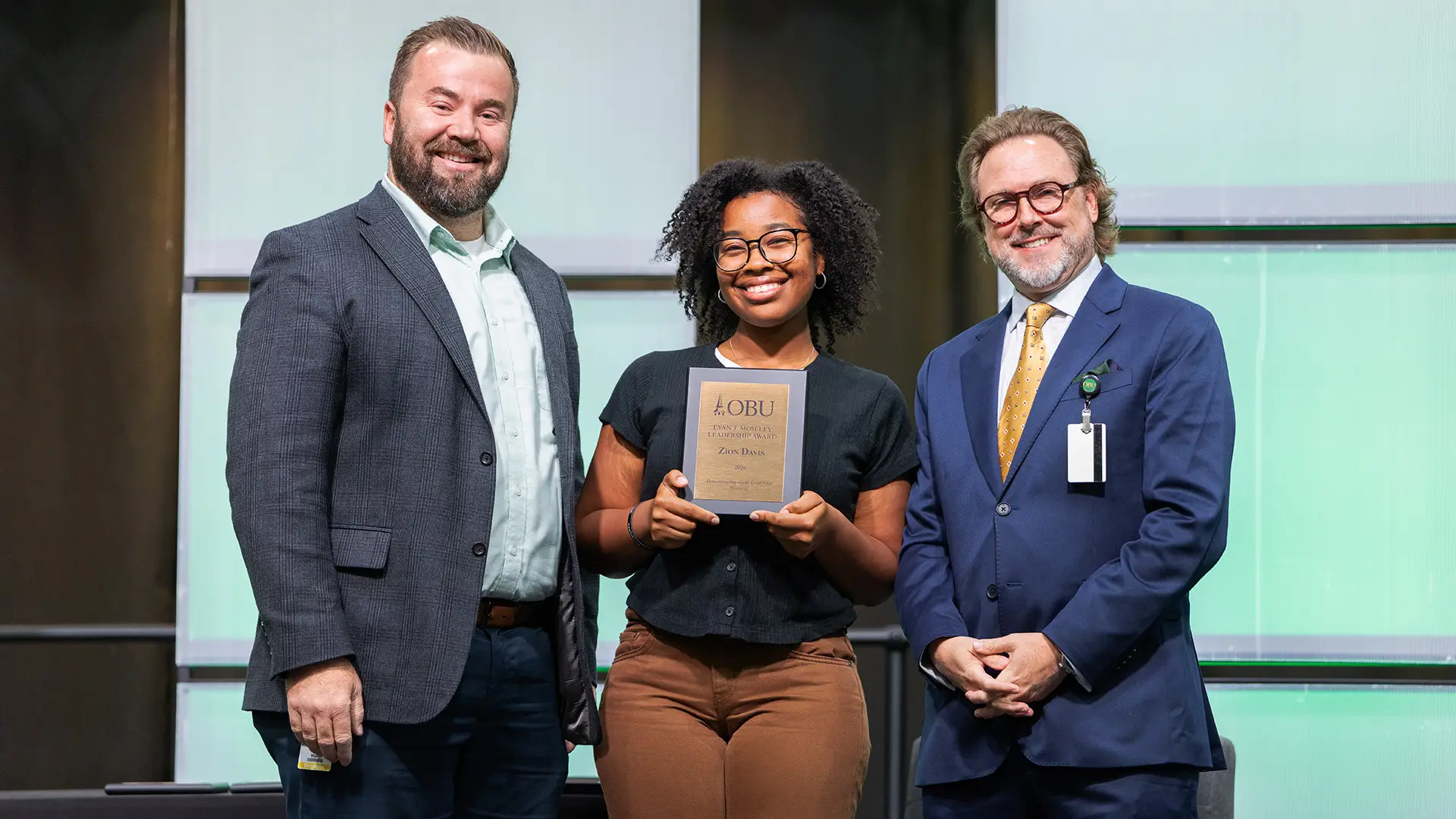 Joe Wuest, vice president of campus life, left, and OBU President Dr. Heath A. Thomas, right, presented The Evans T. Moseley Leadership Award to Zion Davis, center.