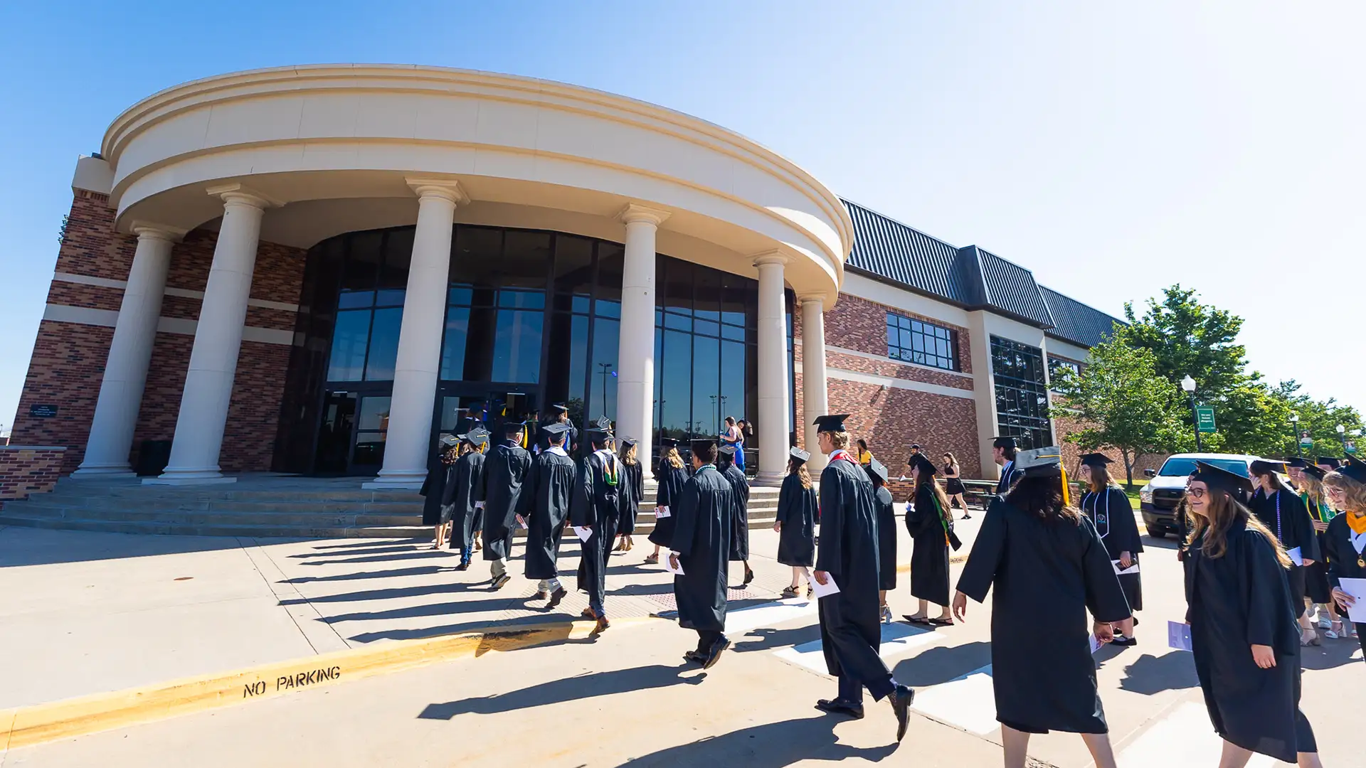 Graduates start the ceremony by walking down University Street and entering the Recreation and Wellness Center.